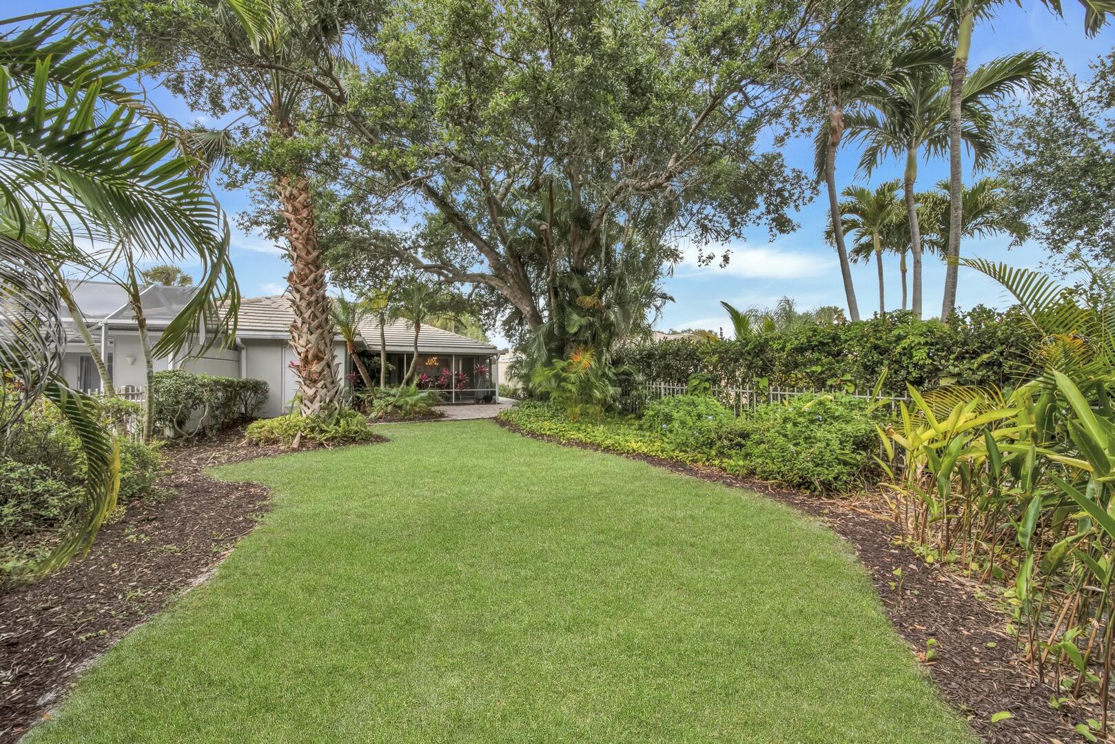 4220 Royal Oak Drive Palm Beach Gardens, FL 33410 - Photo 22 of 35 a front view of a house with a garden