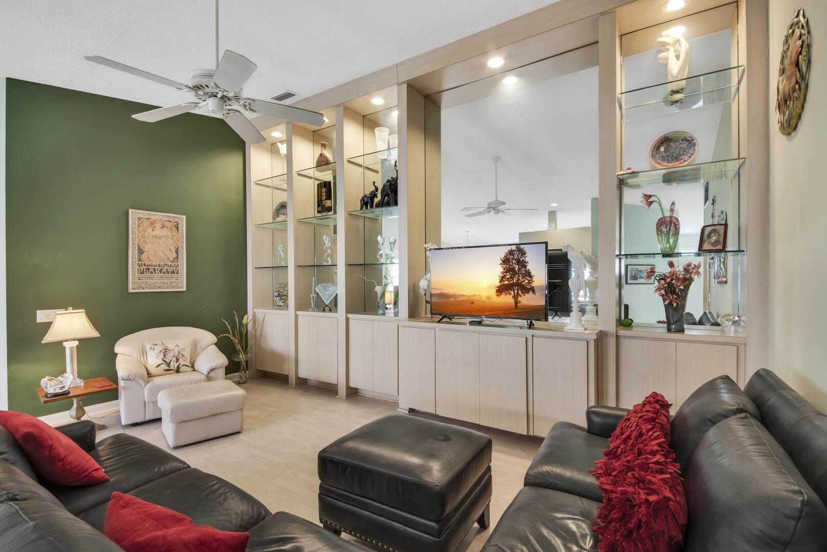 4220 Royal Oak Drive Palm Beach Gardens, FL 33410 - Photo 3 of 35 a living room with furniture and a chandelier