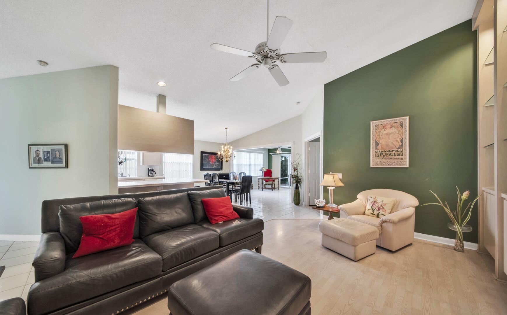 4220 Royal Oak Drive Palm Beach Gardens, FL 33410 - Photo 34 of 35 a living room with furniture and a chandelier