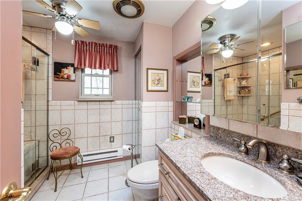 2037 Ridge Road Jeannette, PA 15644 - Photo 15 of 24 a bathroom with a granite countertop toilet a sink and a mirror