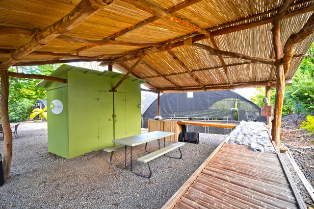 a backyard of a house with wooden floor and outdoor seating