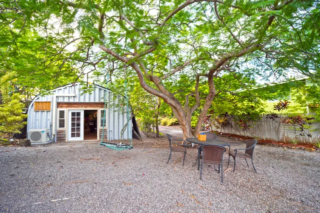 a view of a house with a yard and sitting area