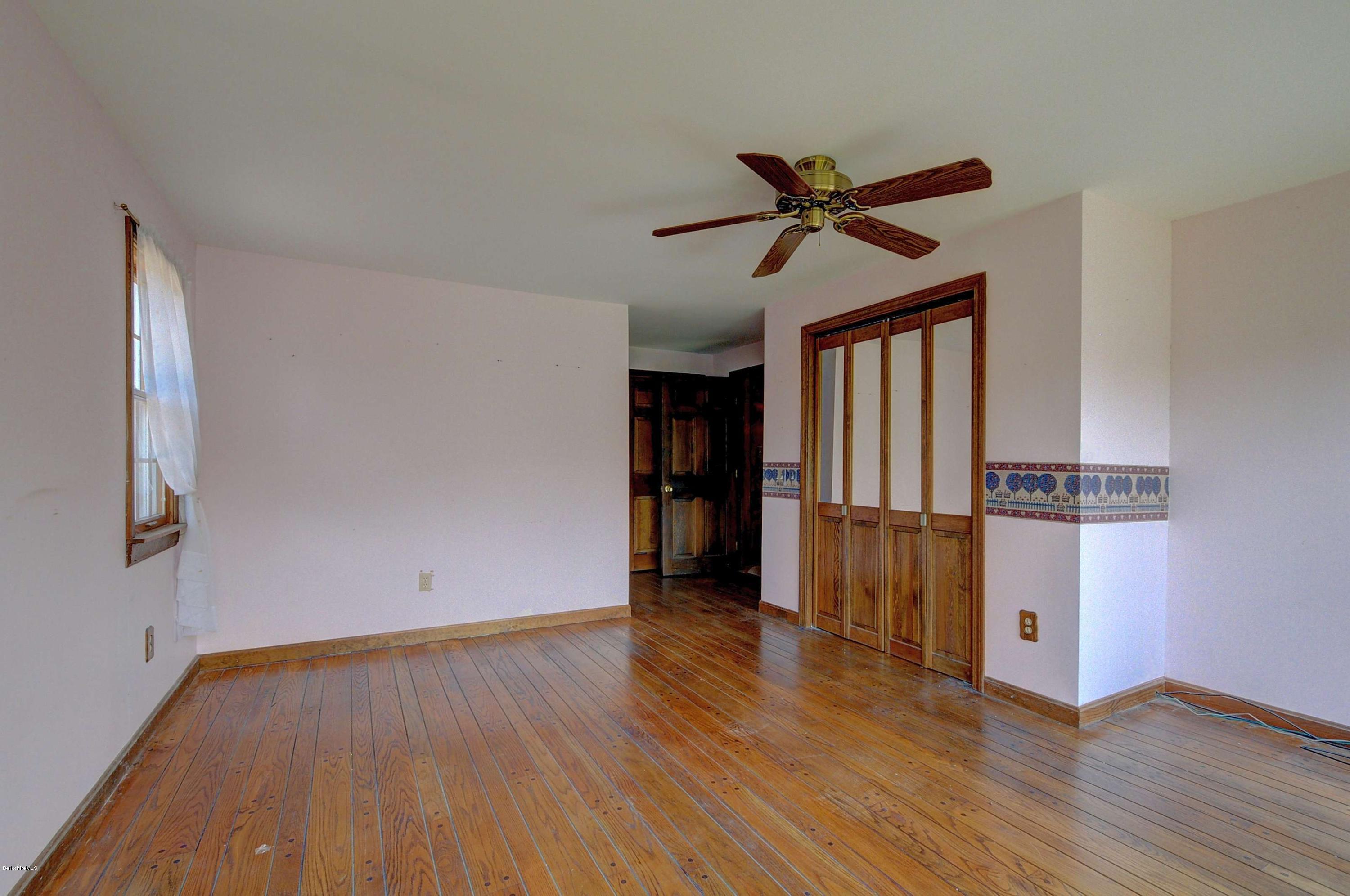 11 Andes Road Peru, MA 01235 - Photo 24 of 29 a view of empty room with wooden floor and fan