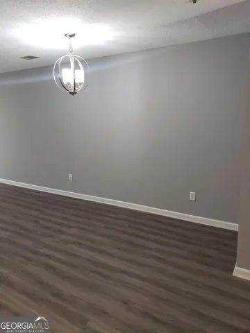 an empty room with wooden floor