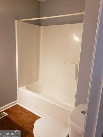 a bathroom with a shower and a toilet