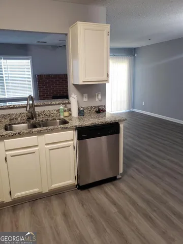 a kitchen with a sink stove and cabinets