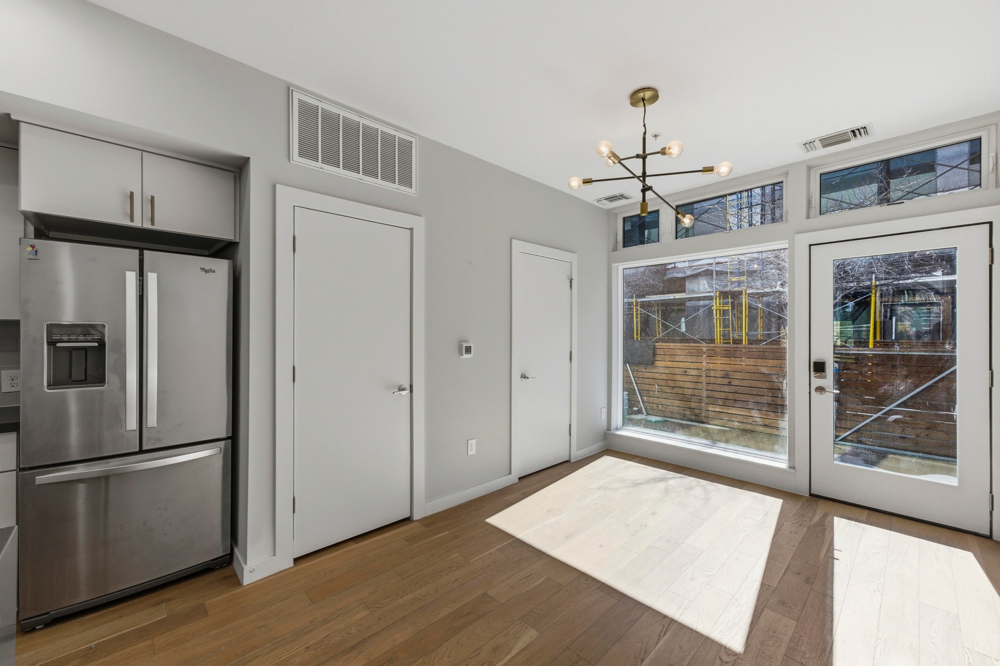 2002 East 7th Street, Unit 242 Austin, TX 78702 - Photo 12 of 34 Unfurnished dining area featuring dark wood finished floors and a chandelier