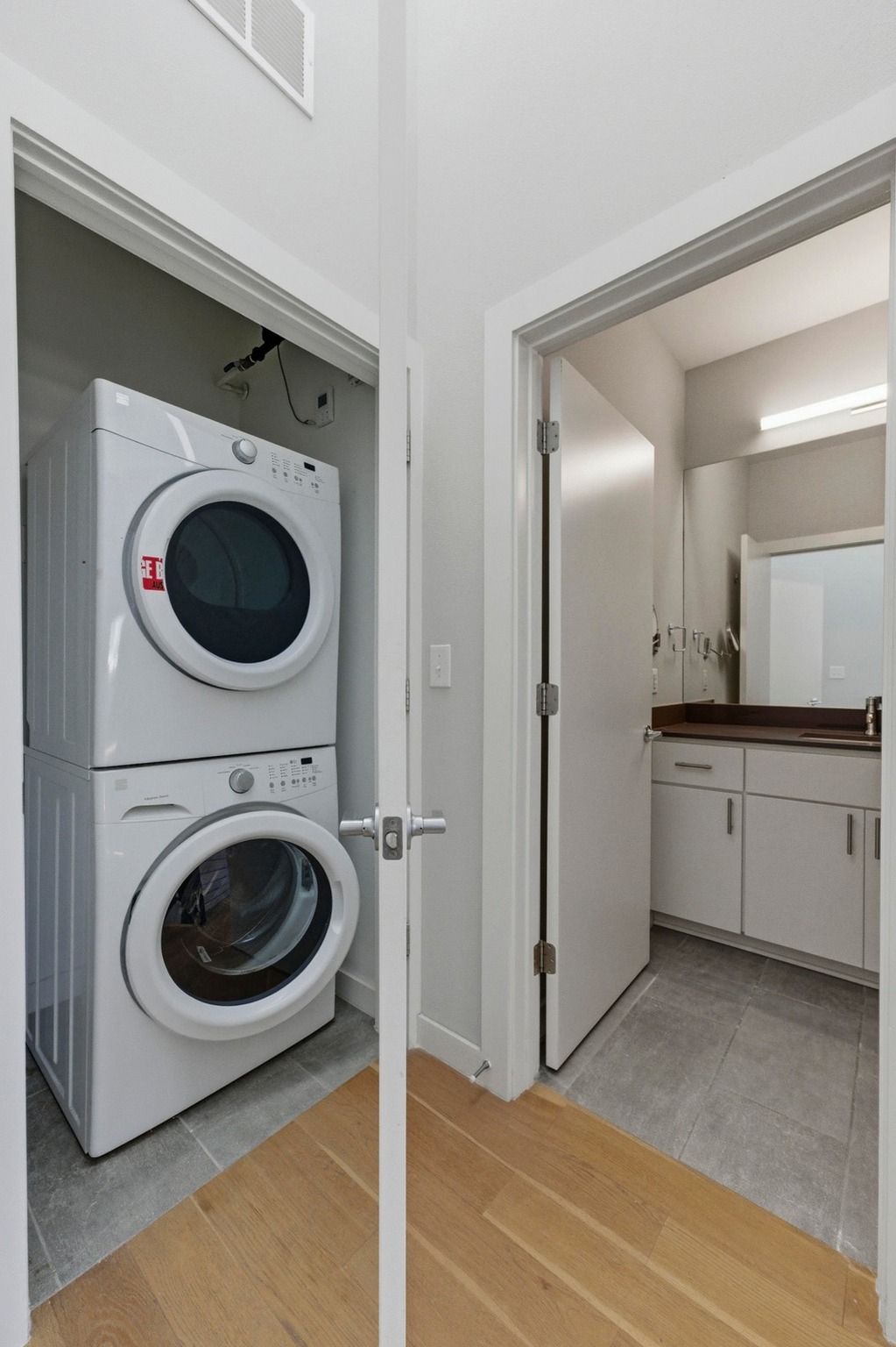 2002 East 7th Street, Unit 242 Austin, TX 78702 - Photo 21 of 34 Laundry room with estacked washer and dryer and light wood-style floors