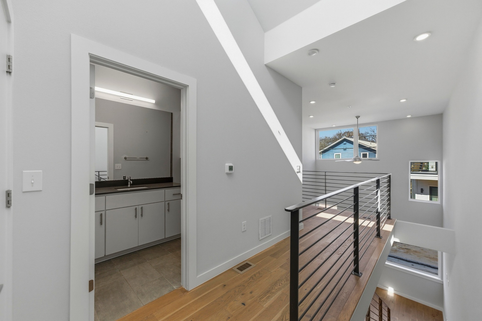 2002 East 7th Street, Unit 242 Austin, TX 78702 - Photo 22 of 34 Corridor featuring an upstairs landing and light wood-style flooring
