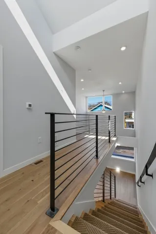 a view of entryway and hall with wooden floor