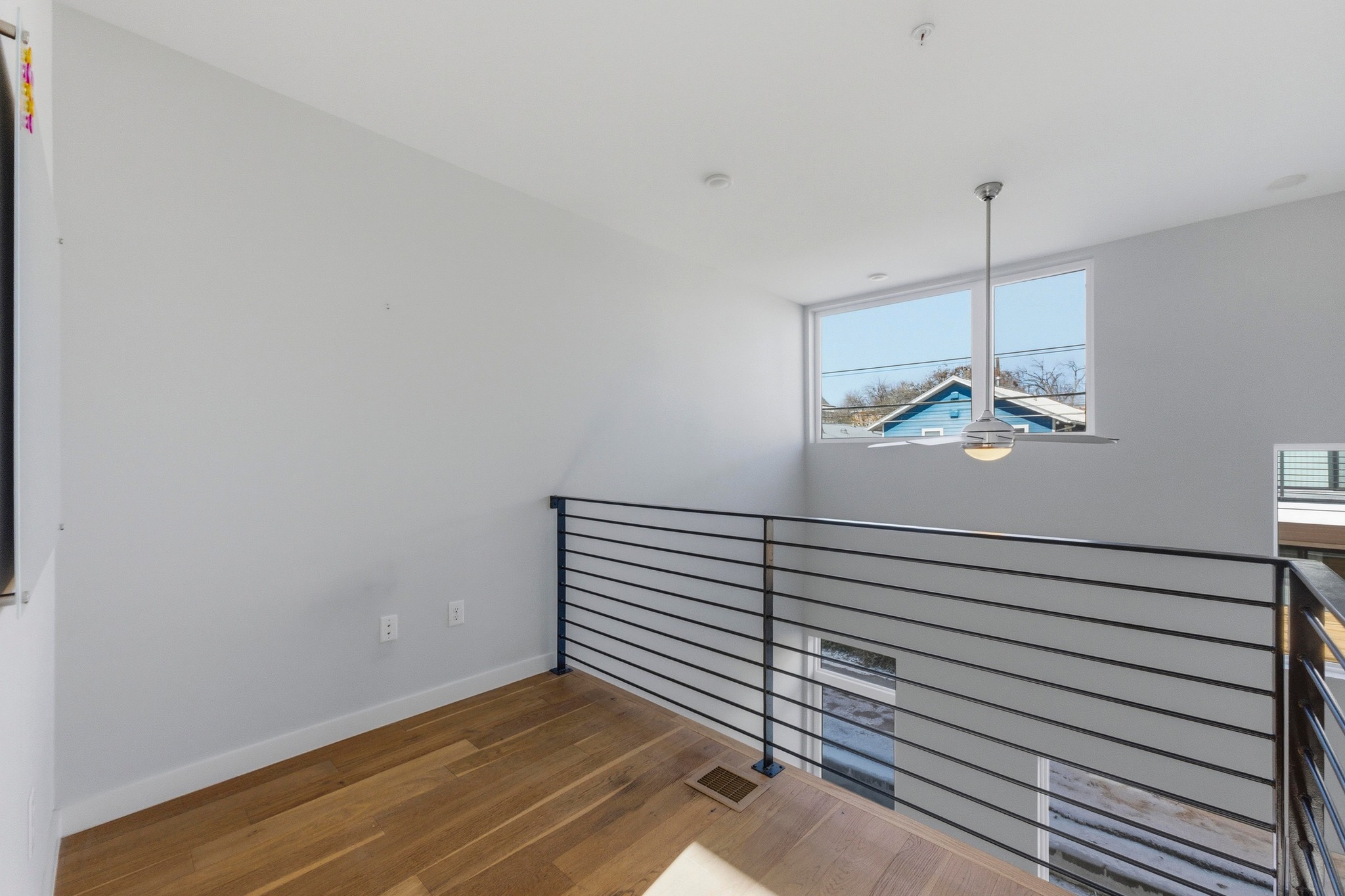 2002 East 7th Street, Unit 242 Austin, TX 78702 - Photo 24 of 34 Spare room with baseboards and wood finished floors