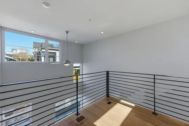 a view of a room with wooden floor