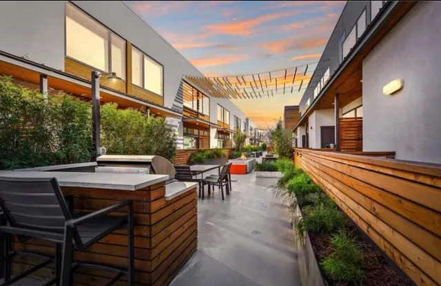 a view of a patio with table and chairs and potted plants