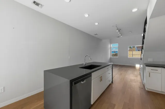 a kitchen with a sink and cabinets