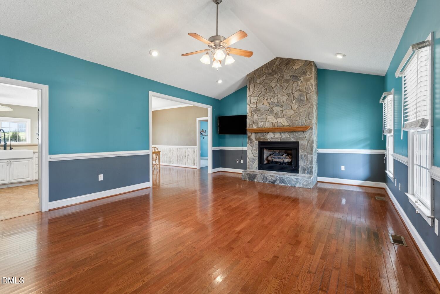 2890 Rosser Road Bear Creek, NC 27207 - Photo 3 of 6 a living room with fireplace and wooden floor