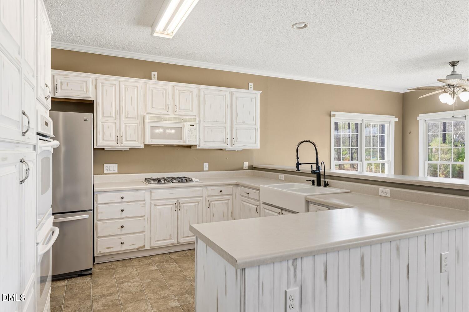 2890 Rosser Road Bear Creek, NC 27207 - Photo 4 of 6 a kitchen with appliances a sink and cabinets