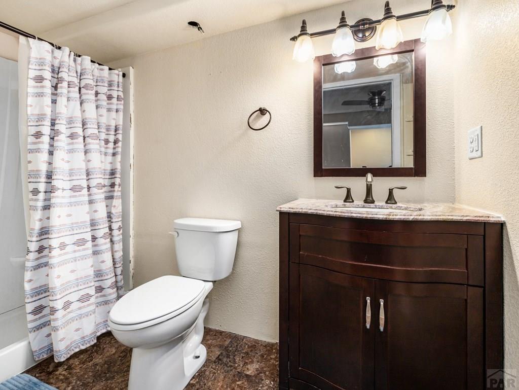 43948 Hunsaker Road Avondale, CO 81022 - Photo 37 of 56 a bathroom with a sink vanity mirror and toilet