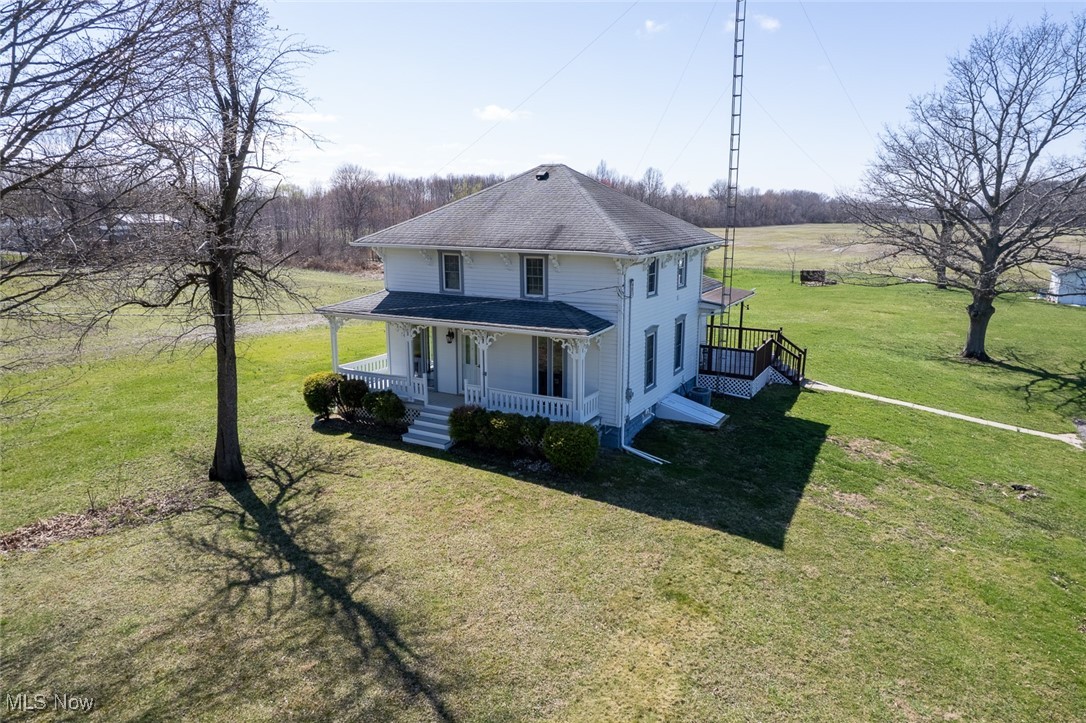 11794 Vermilion Road Oberlin, OH 44074 - Photo 2 of 34 View of front of house with a shingled roof, a front lawn, and a porch