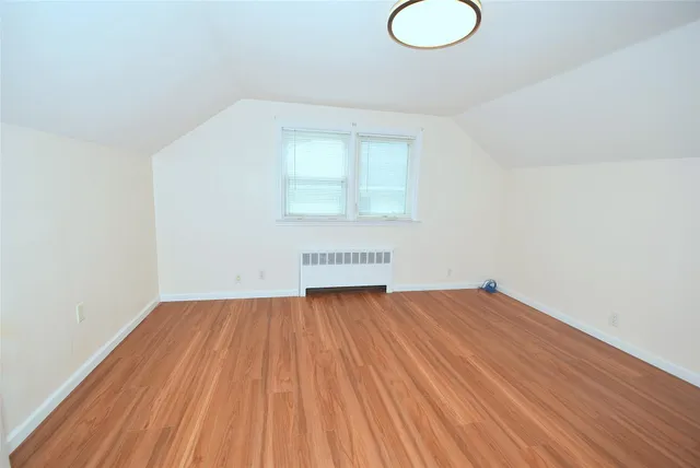 a view of a room with wooden floor and white walls