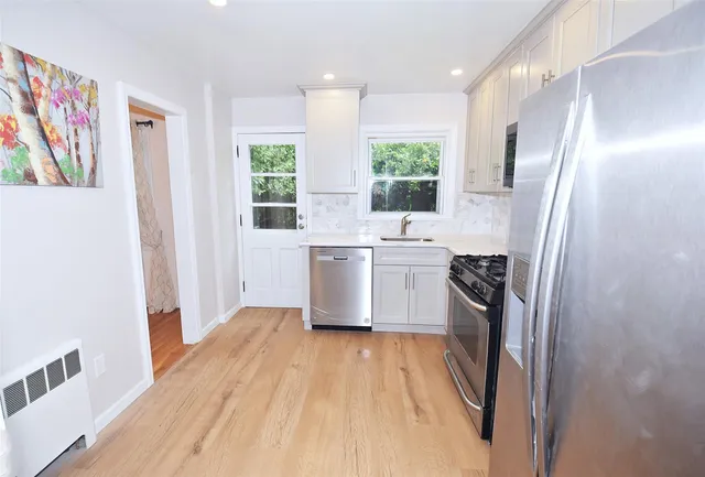 a kitchen with stainless steel appliances a sink and a refrigerator