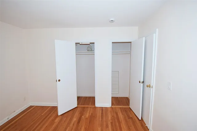 a view of a room with wooden floor and closet