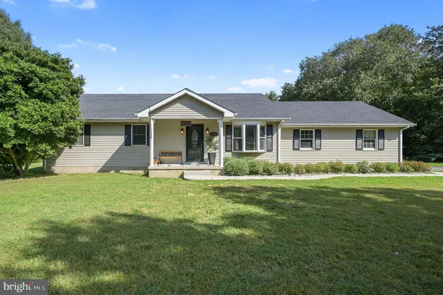 a front view of a house with a yard table and chairs