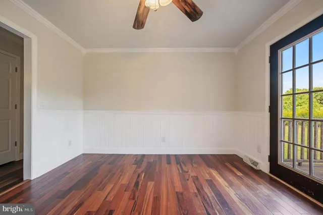wooden floor in an empty room with a window