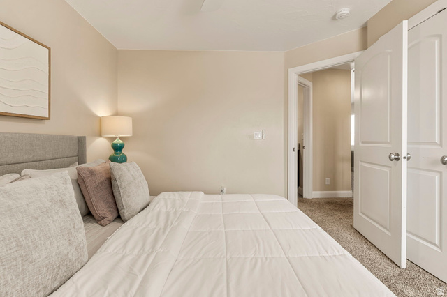 4257 Razor Drive Washington, UT 84780 - Photo 46 of 58 Bedroom featuring neutral-toned walls, textured carpeting, and white paneled doors