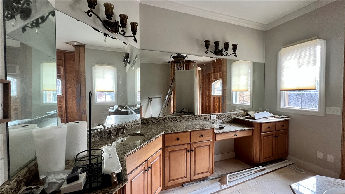 6362 Autumn Ridge Court Decatur, IL 62521 - Photo 16 of 40 a bathroom with a granite countertop sink mirror and a window