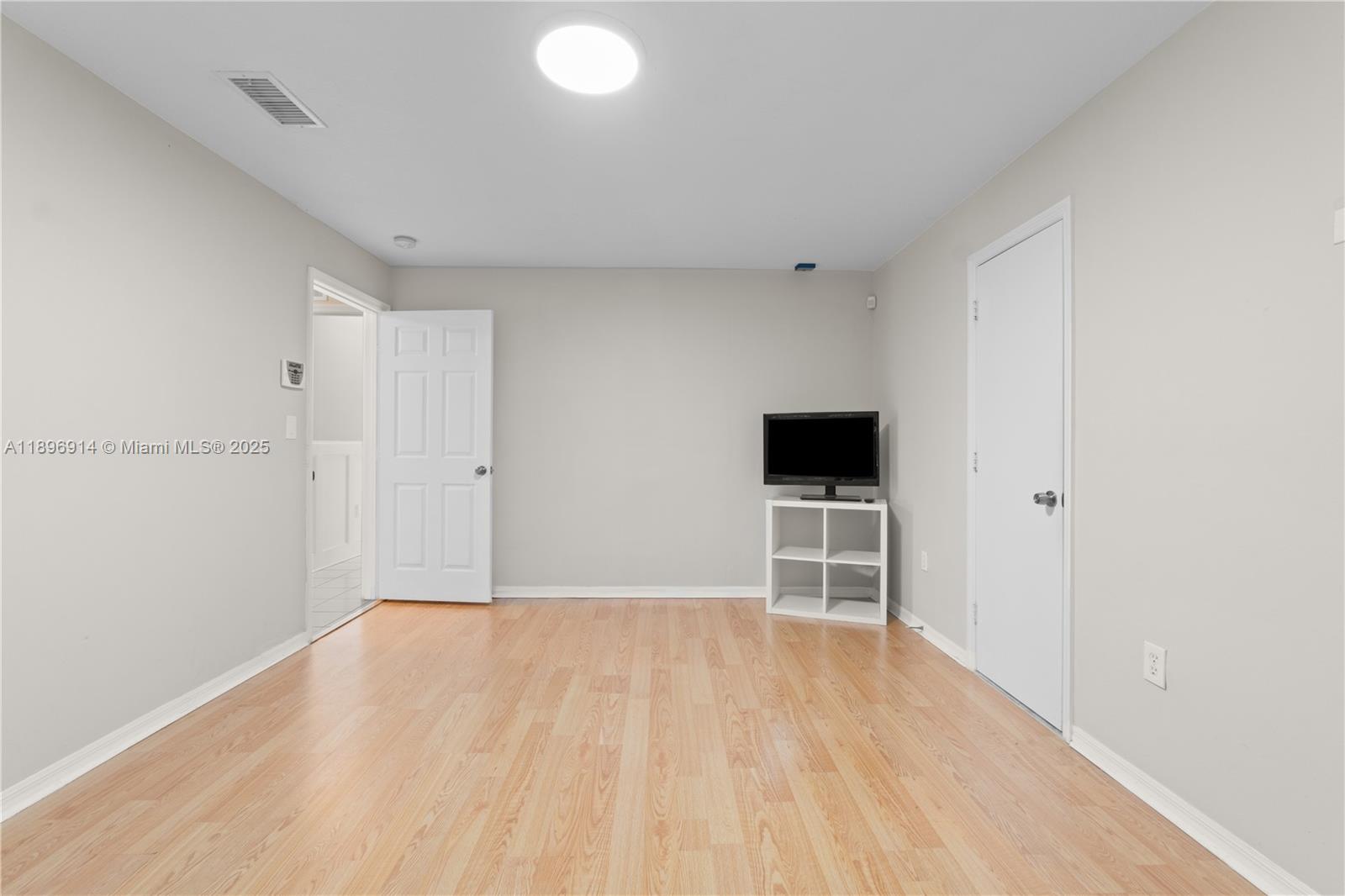 15327 Southwest 179th Terrace Miami, FL 33187 - Photo 12 of 29 a view of an empty room with wooden floor