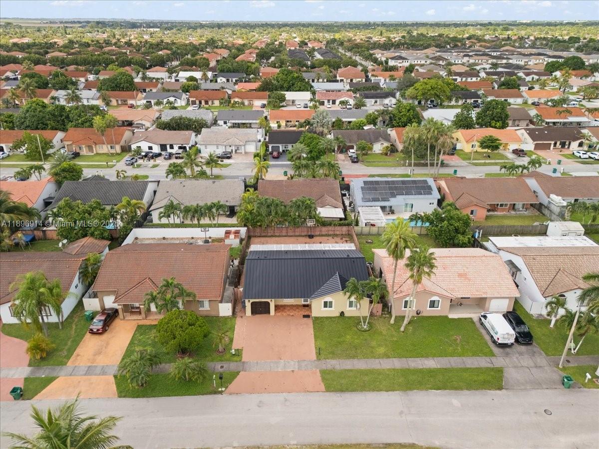 15327 Southwest 179th Terrace Miami, FL 33187 - Photo 6 of 29 an aerial view of a house with a yard and lake view