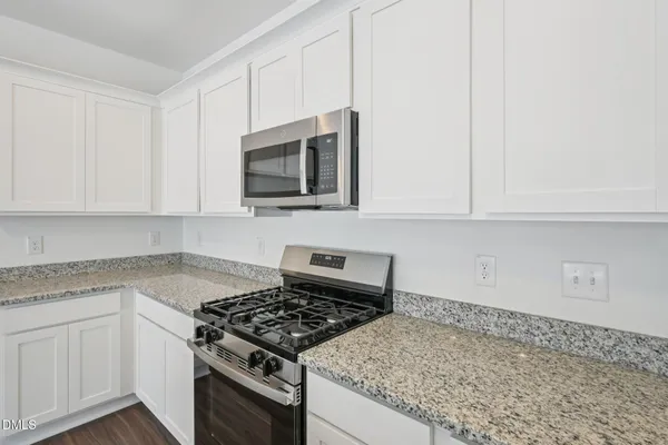 a view of kitchen with sink microwave and stove