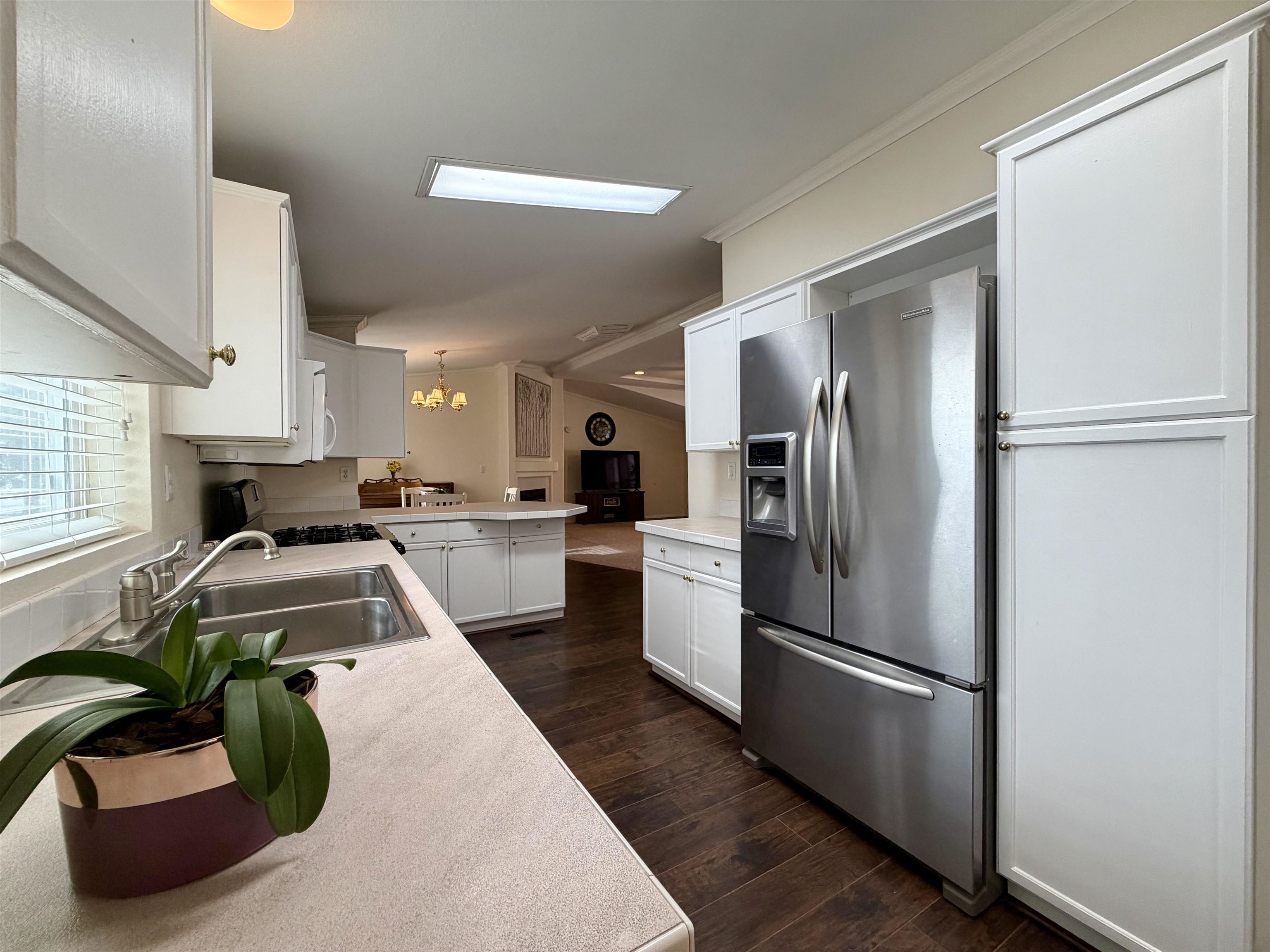 435 32 Road, Unit 480 Clifton, CO 81520 - Photo 10 of 23 a kitchen with stainless steel appliances granite countertop a refrigerator a sink a stove and white cabinets