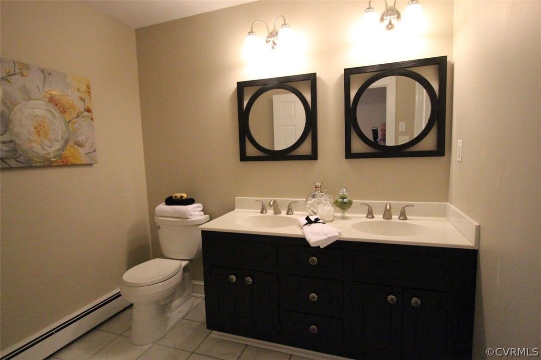 4312 Croatan Road Richmond, VA 23235 - Photo 8 of 26 a bathroom with a toilet a sink and a mirror