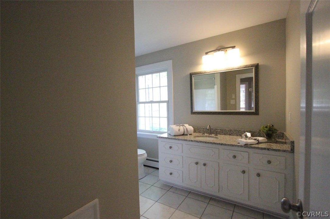 4312 Croatan Road Richmond, VA 23235 - Photo 9 of 26 a bathroom with a double vanity sink and a mirror
