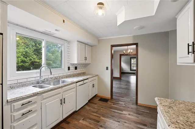 a view of a kitchen counter space with wooden floor and a window