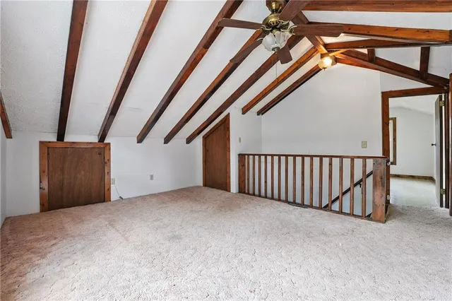 a view of an empty room with stairs