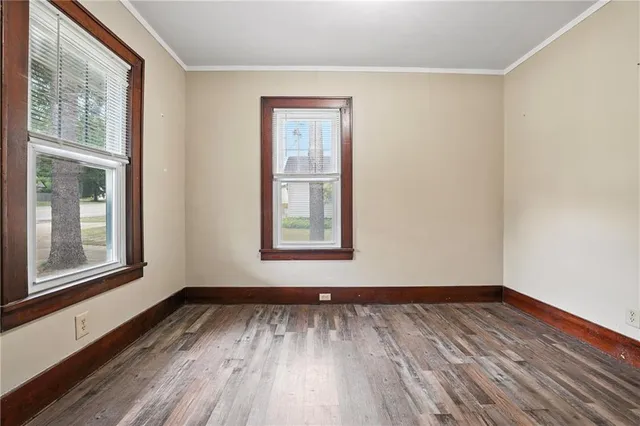 a view of a room with wooden floor and window