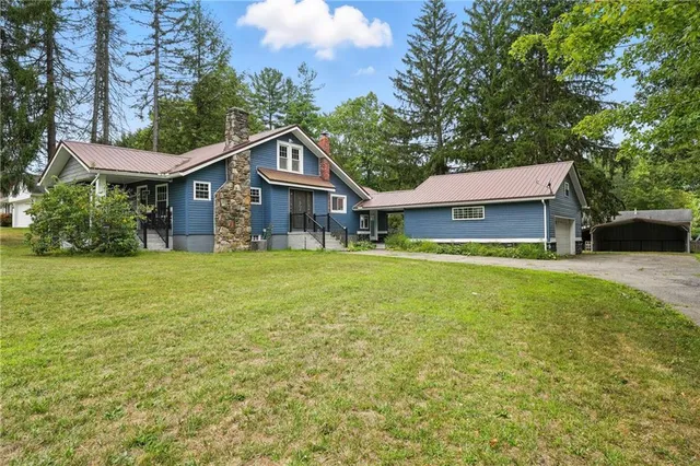 a front view of a house with a garden