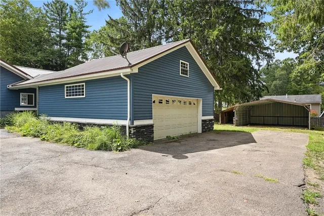 a view of a house with a yard and garage