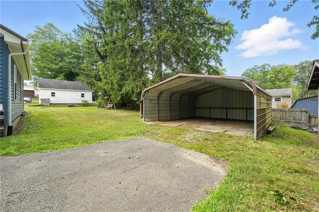 a view of a backyard with a garden and entertaining space