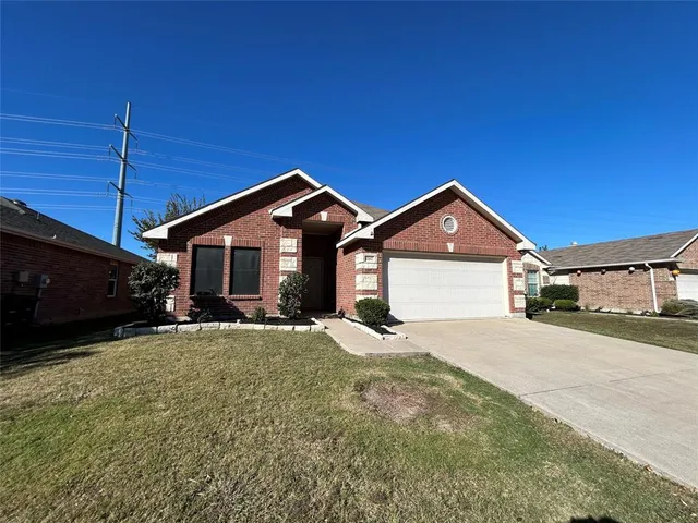 a front view of a house with yard and garage