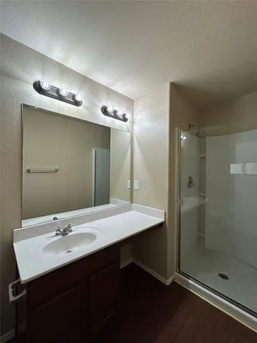 a bathroom with a shower and a sink