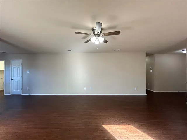 a view of room with hardwood floor and ceiling fan