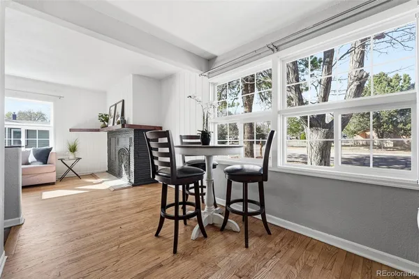 a view of a dining room with furniture window and wooden floor