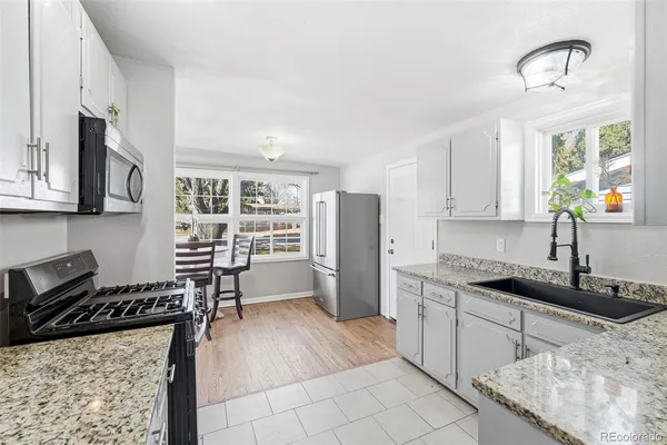 a kitchen with a sink a stove and cabinets