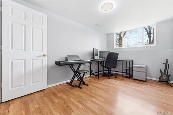 a view of a workspace with furniture and a window