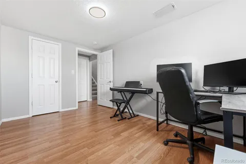 a view of a workspace with furniture and a window