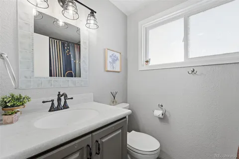 a bathroom with a sink a toilet and mirror