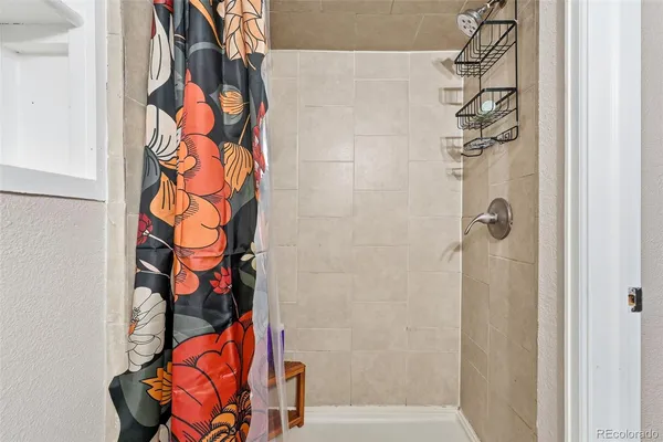a bathroom with a bathtub and shower